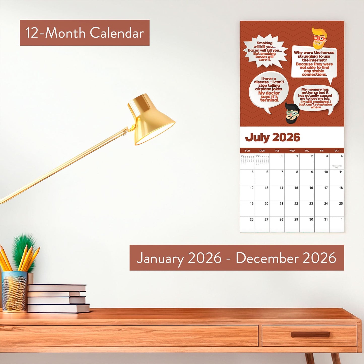 The 2026 Dad Joke Wall Calendar by That Is So Dad hangs above a desk with books, pencils, and a lamp. This funny calendar features comic graphics and witty dad jokes for every month from January to December 2026.