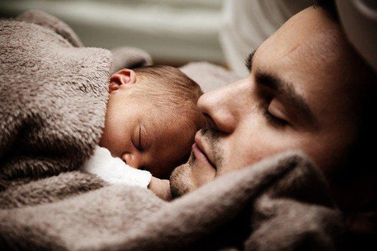 A photo of dad and child sleeping