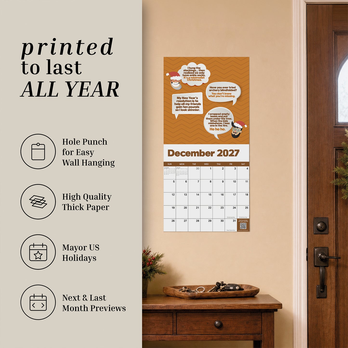 A 2027 Dad Joke Wall Calendar by That Is So Dad hangs by the door, with nearby icons showcasing its easy-hanging design, thick paper, coverage of major US holidays, and handy previews of the next and last months—all topped off with a brand-new dad joke each month to keep your year organized and full of laughs.