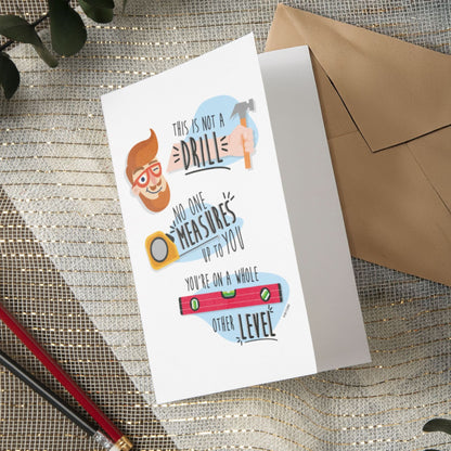 The Funny Father's Day Card "This Is Not A Drill" by That Is So Dad features a man's face, tape measure, and level, with the message: "No one measures up to you. You’re on a whole other level." Durable cardstock; perfect for Father's Day.