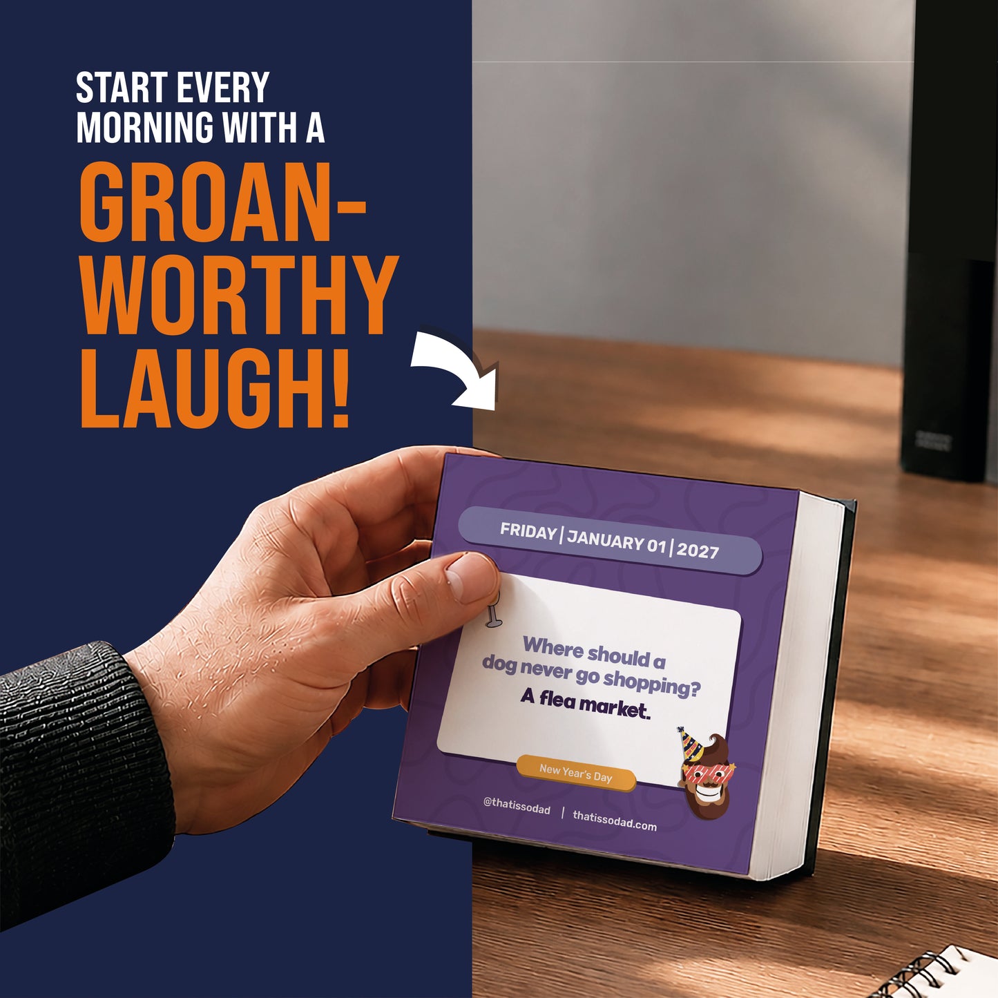 A hand holds the 2027 Daily Dad Joke Desktop Calendar by That Is So Dad, open to a page featuring the joke: “Where should a dog never go shopping? A flea market.” Text above reads: “Kick off each morning with a groan-worthy laugh from daily dad jokes!”.